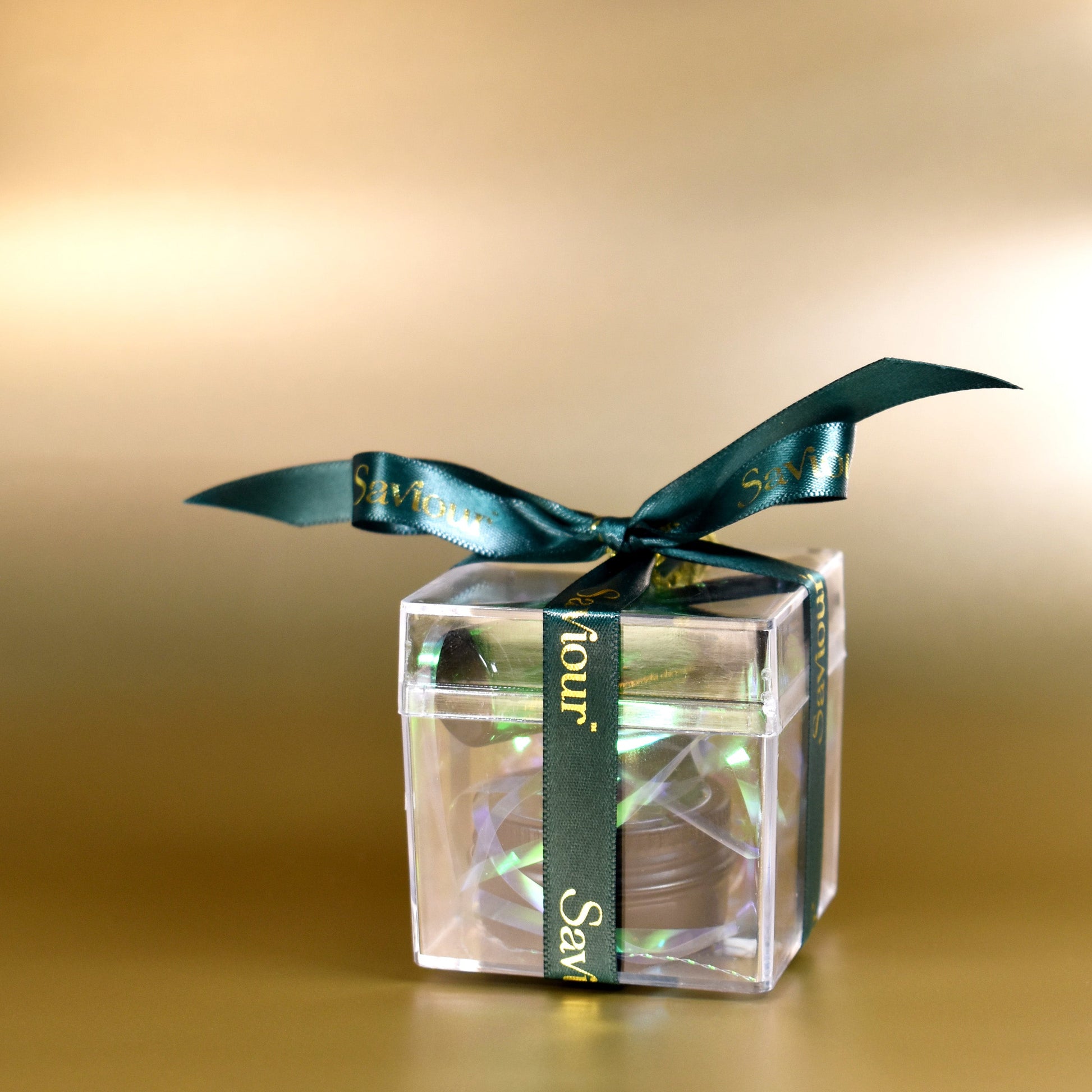 Luxury Clear Bauble with Mini cosmetics tied with a emerald ribbon.